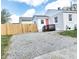 Backyard with gravel parking area, level yard, and a quaint deck and entrance at 1220 Garner Rd, Raleigh, NC 27610