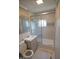 Modern bathroom featuring gray tile, a glass-enclosed shower, and a stylish vanity with contemporary fixtures at 1220 Garner Rd, Raleigh, NC 27610