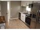 A kitchen featuring stainless steel appliances, a double sink, and ample counter space for cooking preparations at 1220 Garner Rd, Raleigh, NC 27610