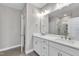 Bathroom featuring a double sink vanity with white cabinets and a large mirror at 1234 Coach Station Alley # 101, Raleigh, NC 27601