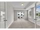 Bright bedroom with neutral walls, carpet, walkout balcony and natural light at 1234 Coach Station Alley # 101, Raleigh, NC 27601