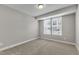 Bedroom featuring plush carpeting and a window offering natural light at 1234 Coach Station Alley # 101, Raleigh, NC 27601