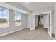 Neutral bedroom with carpet, plenty of light, and interior door at 1234 Coach Station Alley # 101, Raleigh, NC 27601