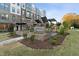 Brick courtyard with fire-feature, landscaping, and adjacent townhomes at 1234 Coach Station Alley # 101, Raleigh, NC 27601