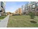 Exterior view of new townhomes, featuring manicured lawns and modern architecture against a blue sky at 1234 Coach Station Alley # 101, Raleigh, NC 27601