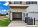 Two-car garage attached to a townhome with modern AC units at 1234 Coach Station Alley # 101, Raleigh, NC 27601