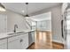 Modern kitchen island view leading into the spacious living room with natural lighting at 1234 Coach Station Alley # 101, Raleigh, NC 27601