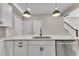 Kitchen island featuring a stainless steel dishwasher, and faucet with bar-style pendant lighting at 1234 Coach Station Alley # 101, Raleigh, NC 27601