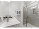 Modern bathroom featuring vanity with quartz countertop and tiled stand-up shower with shelving at 1245 S Blount Street # 201, Raleigh, NC 27601