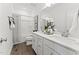 Bright bathroom featuring dual sinks, white cabinetry, and a shower-tub combination, exuding a clean and modern aesthetic at 1245 S Blount Street # 201, Raleigh, NC 27601