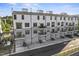 Contemporary townhome exteriors showcasing gray brick and white siding, with balconies and garages providing a stylish and functional design at 1245 S Blount Street # 201, Raleigh, NC 27601