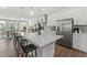 Open kitchen featuring stainless steel appliances, grey backsplash, and a large island with seating at 1245 S Blount Street # 201, Raleigh, NC 27601