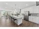 Spacious kitchen with modern appliances, long island with seating, and open dining area at 1245 S Blount Street # 201, Raleigh, NC 27601