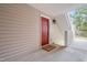 Welcoming red front door with a doormat that reads 'Welcome Home' at 1300 Hillbrow Ln # 204, Raleigh, NC 27615