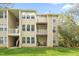 View of exterior of building with multiple balconies and grassy lawn at 1300 Hillbrow Ln # 204, Raleigh, NC 27615