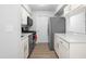 Galley kitchen with white cabinets, marble countertops, and stainless steel appliances at 1300 Hillbrow Ln # 204, Raleigh, NC 27615