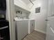 A convenient laundry room features a washer and dryer with built-in shelving for storage at 1300 Hillbrow Ln # 204, Raleigh, NC 27615