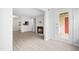 Spacious living room with fireplace, open floor plan, light wood floors, and door to the exterior at 1300 Hillbrow Ln # 204, Raleigh, NC 27615