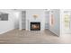 Open-concept living room with built-in shelving and a cozy fireplace at 1300 Hillbrow Ln # 204, Raleigh, NC 27615