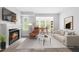 Bright living room featuring a fireplace, large windows, and space for a home office setup at 1300 Hillbrow Ln # 204, Raleigh, NC 27615