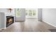 Bright living room featuring a fireplace and large windows with natural light at 1300 Hillbrow Ln # 204, Raleigh, NC 27615