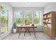 Bright home office filled with light and featuring a modern desk and bookcase at 1300 Hillbrow Ln # 204, Raleigh, NC 27615