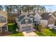 Aerial view of a two-story home with brick accents and well-manicured lawn and landscaping at 1301 Elliott Ridge Ln, Morrisville, NC 27560