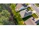Aerial view of a backyard with green grass, a wood deck with chairs, and nearby forest at 1301 Elliott Ridge Ln, Morrisville, NC 27560
