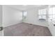 Bright bedroom featuring neutral carpet, white walls, and natural light from multiple windows at 1301 Elliott Ridge Ln, Morrisville, NC 27560