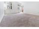 Bright bedroom featuring neutral carpet, white walls, and a window looking out to a wooded backyard at 1301 Elliott Ridge Ln, Morrisville, NC 27560