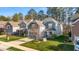 View of attractive two-story home with gray siding and a brick-accented garage at 1301 Elliott Ridge Ln, Morrisville, NC 27560