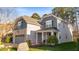 Charming two-story home with a combination of gray siding and brick exterior at 1301 Elliott Ridge Ln, Morrisville, NC 27560