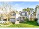 Beautiful home with a lush green lawn, mature tree, and charming exterior details, all in a well-maintained neighborhood at 1301 Elliott Ridge Ln, Morrisville, NC 27560