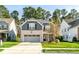 Charming two-story home with a brick and gray exterior, a well-manicured lawn, and an attached two-car garage at 1301 Elliott Ridge Ln, Morrisville, NC 27560