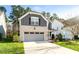 Attractive two-story home with a two-car garage, showcasing its well-maintained lawn and appealing facade at 1301 Elliott Ridge Ln, Morrisville, NC 27560