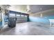 Spacious garage with an overhead door, laundry sink, and storage at 1301 Elliott Ridge Ln, Morrisville, NC 27560