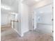 Bright hallway with neutral carpet, white walls, and white railing leading to additional rooms at 1301 Elliott Ridge Ln, Morrisville, NC 27560