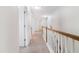 Hallway with neutral carpet, white walls, and white railing at 1301 Elliott Ridge Ln, Morrisville, NC 27560