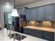This kitchen has gray cabinets, stainless appliances and modern countertops at 1301 Elliott Ridge Ln, Morrisville, NC 27560