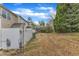 View of townhome backyards and exteriors featuring green shrubs and a fenced-in area at 1304 Cozart St # 258, Durham, NC 27704
