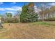 View of a townhome backyard featuring shrubs and a green grass area at 1304 Cozart St # 258, Durham, NC 27704