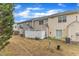 A view of townhome backyards and exteriors featuring green shrubs and a fenced-in area at 1304 Cozart St # 258, Durham, NC 27704