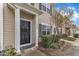 Home entrance with a black door, white trim, manicured shrubs, and a small garden bed at 1304 Cozart St # 258, Durham, NC 27704