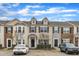 Attractive townhomes featuring stone and siding exteriors, dormer windows, and well-maintained landscaping at 1304 Cozart St # 258, Durham, NC 27704