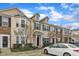 Charming townhome featuring beige siding, black shutters, and stone accents for added curb appeal at 1304 Cozart St # 258, Durham, NC 27704