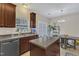 A view of an eat-in kitchen area with a center island, neutral walls, and a door to the exterior at 1304 Cozart St # 258, Durham, NC 27704