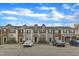 Street view of townhomes with varied siding, dormer windows, and convenient parking at 1304 Cozart St # 258, Durham, NC 27704