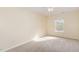 Bright bedroom features tan carpet and a window for natural light at 1311 Canyon Rock Ct # 105, Raleigh, NC 27610