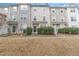 Attractive townhome exteriors with neutral siding and neatly manicured bushes at 1311 Canyon Rock Ct # 105, Raleigh, NC 27610