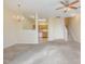 Open-concept living area showcasing carpet floors, a ceiling fan, and access to the kitchen at 1311 Canyon Rock Ct # 105, Raleigh, NC 27610